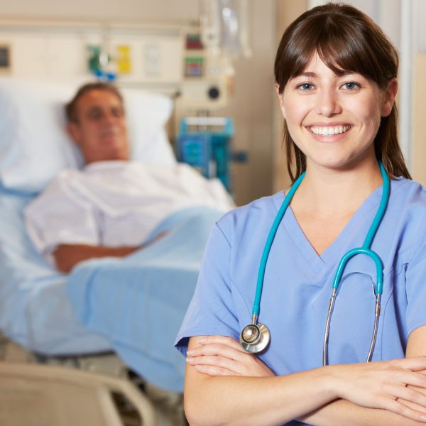 Portrait Of Nurse With Patient In Background